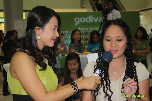 claudette centeno talks with an audience during Godiva launching